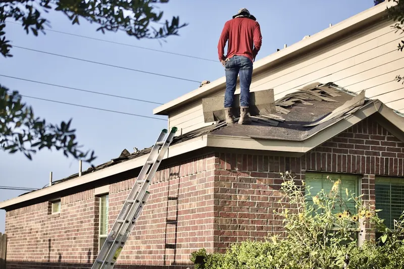 Professional roofer working on a residential roof in Gwynmont Farms